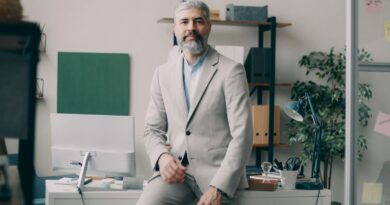 A man sitting on a desk in an office