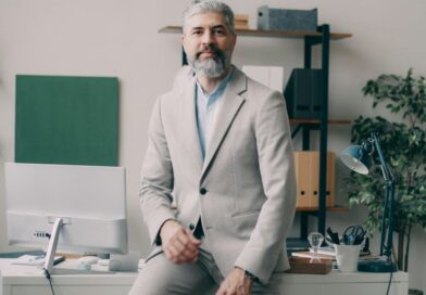A man sitting on a desk in an office